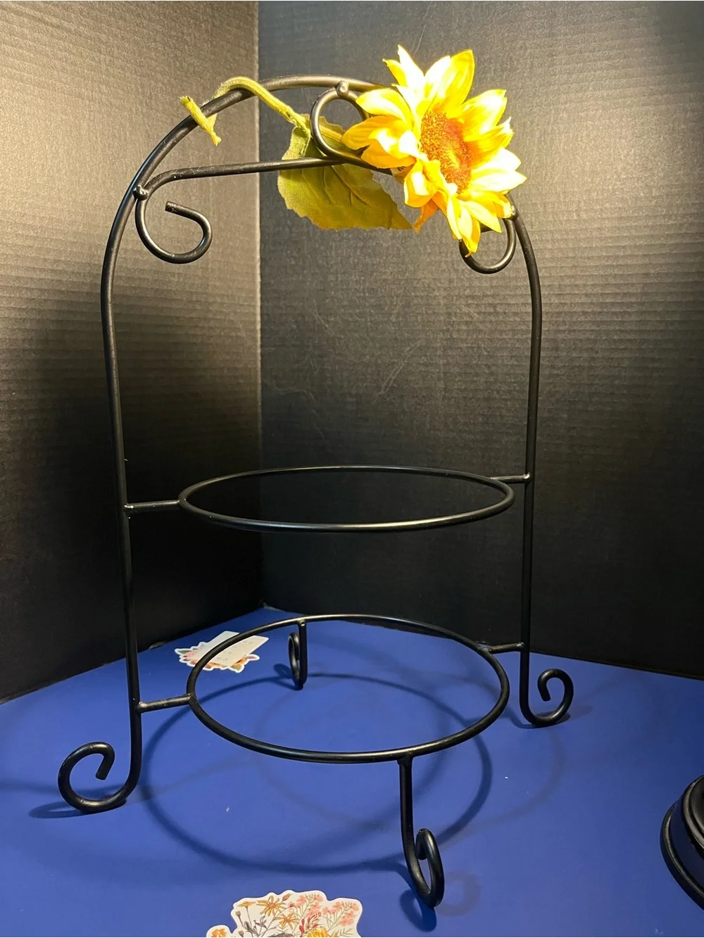 Black Two-Tier Metal Display Stand with Sunflower Accent